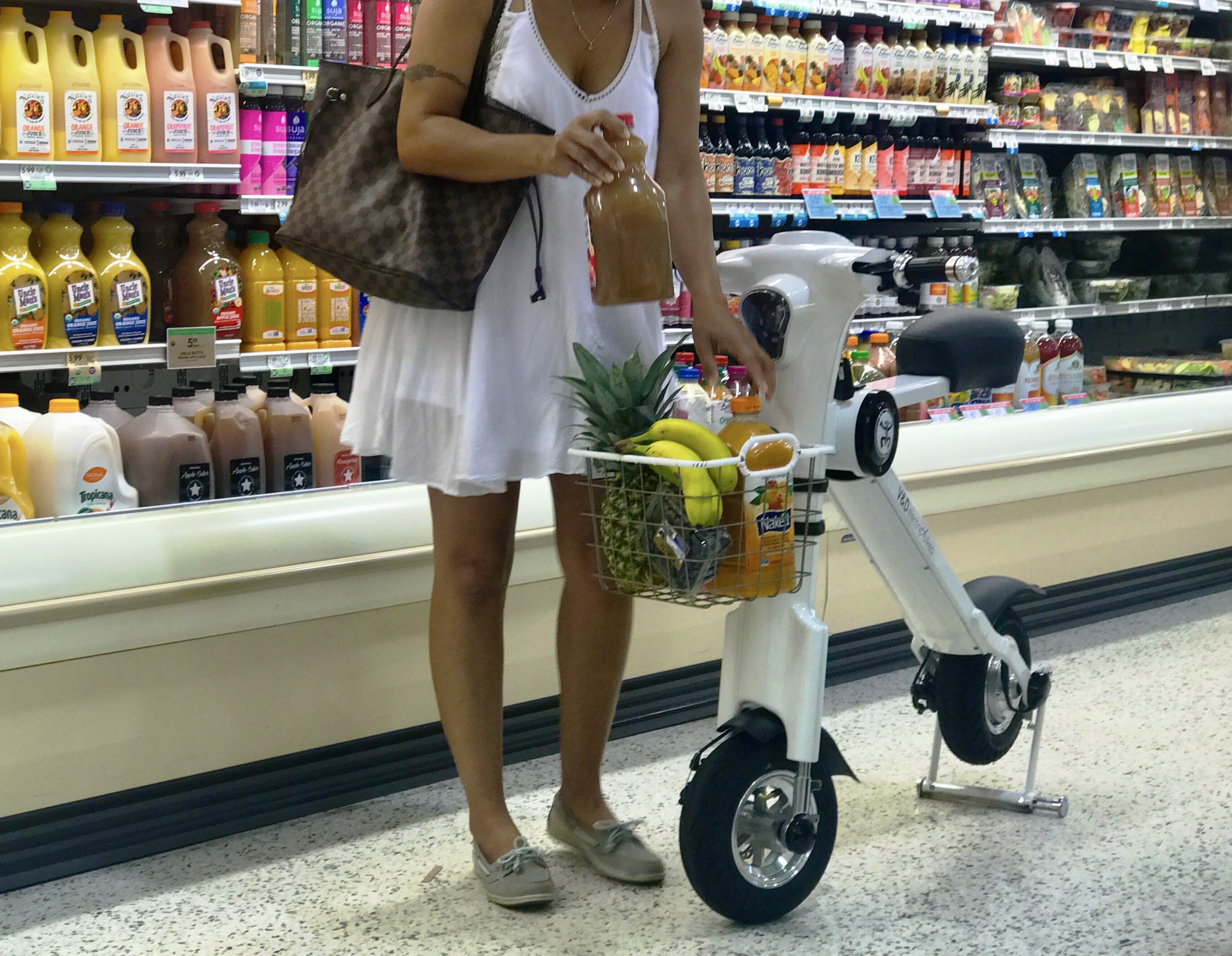 woman with electric bike in grocery store